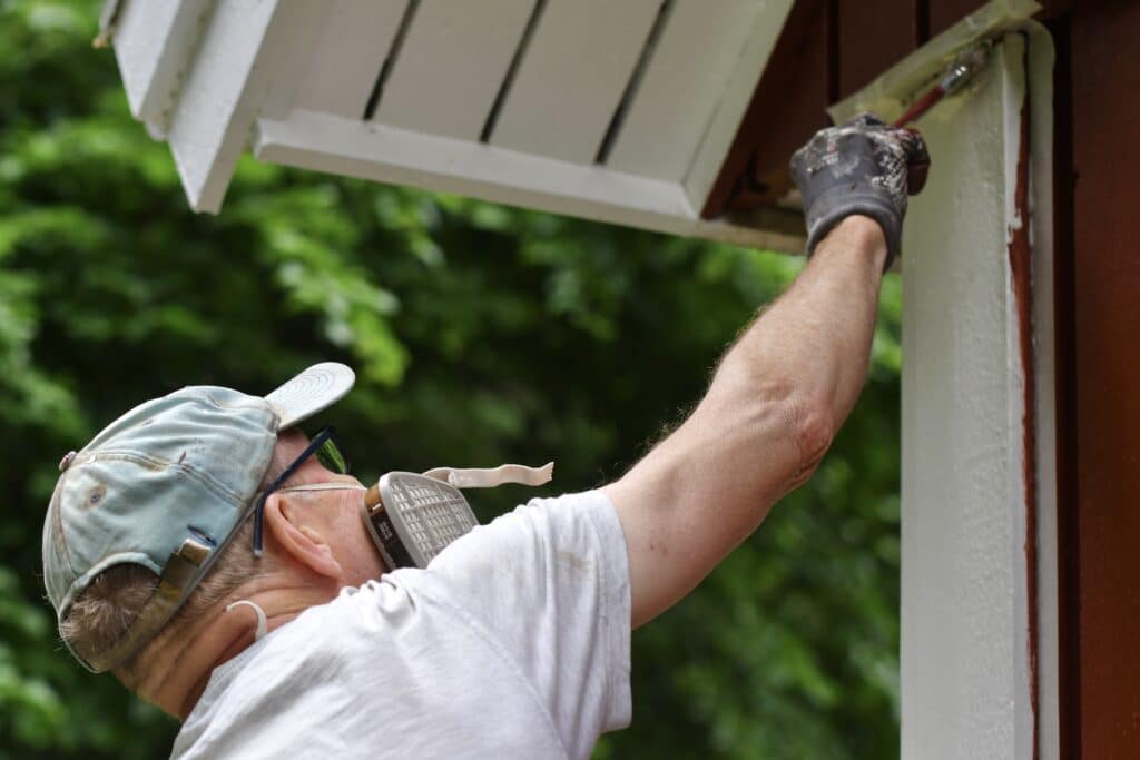 Top Ways To Prepare Your Home For Exterior Painting - man painting house