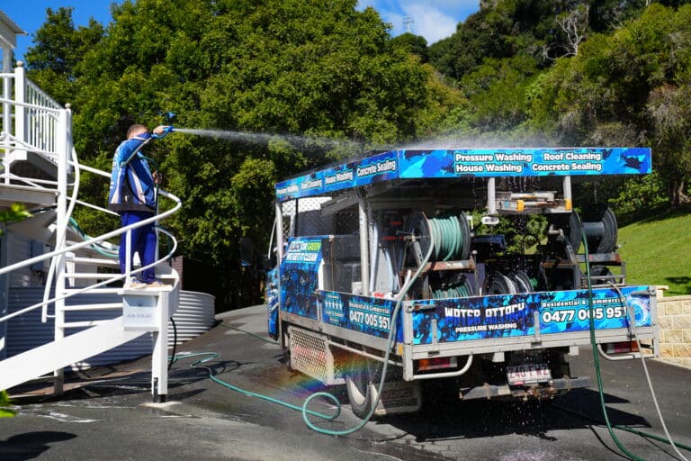 Jon washing the Water Attack truck in front of Maleny Manor