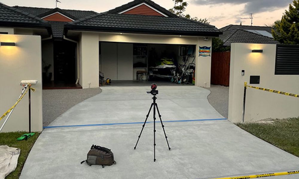 Water Attack Pressure Washing – Concrete Sealing Proccess concrete driveway sealer - house with yellow tape
