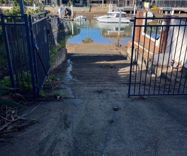 Boat Ramp cleaning - far view of wet boat ramp and waterway