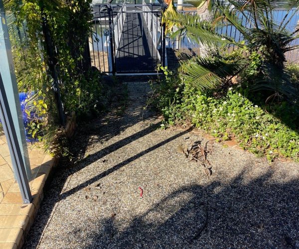 Boat Ramp cleaning - view of dirty pathway going to a doc