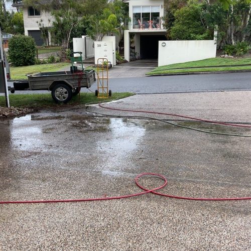 Pressure Cleaning Brisbane - wet driveway and lawn